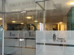 a store window with a store acaya sign on it at Panoramic Luxury of Bogotá in Bogotá