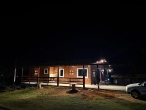 a house at night with a car parked in front at Sua casa na serra in Bezerros