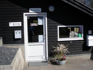 a phone booth in front of a building at Vejle City Camping in Vejle