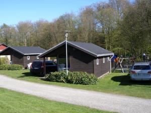 a building with a car parked in front of it at Vejle City Camping in Vejle