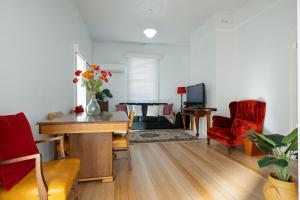a living room with a table and chairs and a couch at Walk To City & Hospital in Kings Park