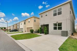 a row of apartment buildings with a driveway at Stylish 5-Bedroom Villa - Perfect Disney Getaway! in Davenport