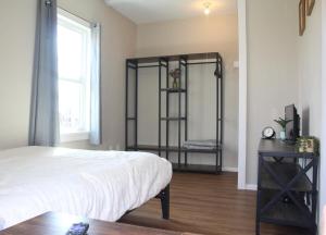 a bedroom with a bed and a table and a window at Peaceful Family Retreat with Games and Glamping! in Livingston