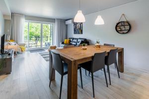 a dining room with a wooden table and chairs at Le Céleste mountain view 4 beds in Beaupré