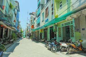 a row of motorcycles parked on the side of a street at Thanh An 3 Guesthouse in Hue