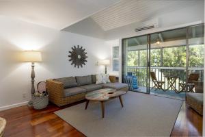a living room with a couch and a table at Turtle Bay Kuilima 150 East condo in Kahuku