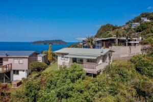 an aerial view of a house on a hill at Tideview Cottage - Incredible Views - Tairua in Tairua