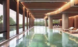 a pool in the middle of a building with windows at Antara Residence By Sleeping Lion in Genting Highlands
