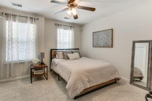 a bedroom with a bed and a ceiling fan at Historic District Retreat in Bluffton
