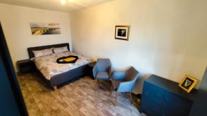 a bedroom with a bed and a table and chairs at Golden Hop Apartments in Senftenberg