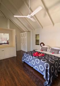 a bedroom with a large bed with flowers on it at Beachfront Villa - Pod House, Private Plunge Pool in Savusavu +22 photos
