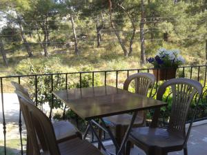 a table and chairs on a porch with a fence at Rose Apart in Sarigerme