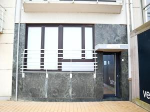 a facade of a building with windows and a door at Attic Apartment Nieuwpoort near Beach in Nieuwpoort