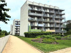 an apartment building in front of a walkway at Krejcarek Garden Apartment in Prague