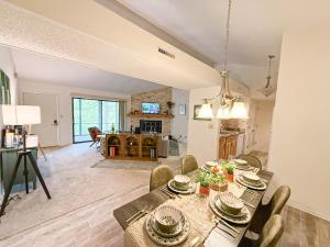 a dining room and living room with a table and chairs at Putters Paradise-2Bed2BathGrillFirepit-10PP in Osage Beach