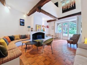 a living room with a couch and a fireplace at Charmante Villa à Montauroux, Piscine Privée, 8 Pers., Golf - FR-1-779-10 in Montauroux