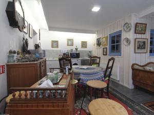 a kitchen with a table and chairs in a room at Charmant Studio avec Jardin et Terrasses, Environnement Calme et Historique - FR-1-583-383 in Mersuay