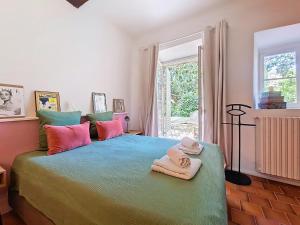 a bedroom with a large bed with towels on it at Charmante Villa à Montauroux, Piscine Privée, 8 Pers., Golf - FR-1-779-10 in Montauroux +17 photos
