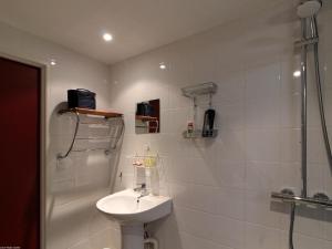 a white bathroom with a sink and a shower at Charmant Studio avec Jardin et Terrasses, Environnement Calme et Historique - FR-1-583-383 in Mersuay +25 photos