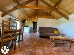 a living room with a couch and a table at Charmante chaumière traditionnelle dans le Marais breton - FR-1-426-584 in Beauvoir-sur-Mer