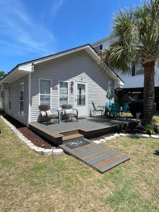 a backyard with a deck and a house at Beach House in Oceanlakes Campgrounds Myrtle Beach, South Carolina in Myrtle Beach