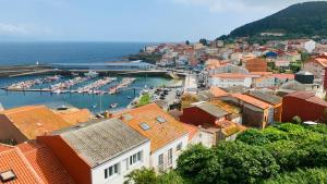 a city with boats docked in a harbor at Pension Lopez in Fisterra