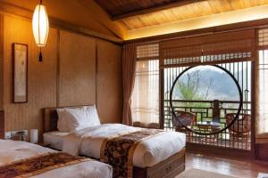 Postel nebo postele na pokoji v ubytování Ganzhou Banjiangxia Homestay