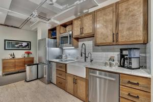 a kitchen with wooden cabinets and a stainless steel refrigerator at Rustic Suite 6BR by Maddox Hotel in Nashville +32 photos