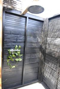 a black garage door with a plant on it at De Veldeling in Hollandscheveld