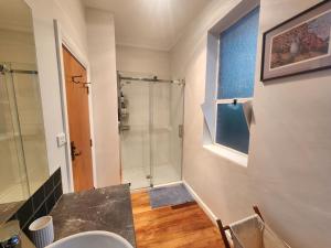 a bathroom with a shower and a sink at The Church House- Boutique Comfort in Balclutha +12 photos