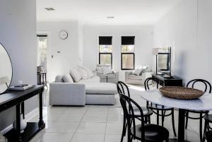 a living room with a couch and a table and chairs at Belle Maison - Glenelg, Cafe, Family, Beach in Glenelg +20 photos