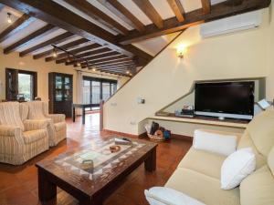 a living room with a couch and a tv at Cottage in Navas de Estena with Pool & Jacuzzi in Navas de Estena