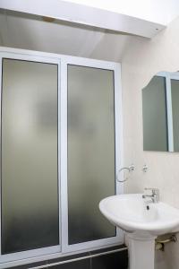 a bathroom with a sink and a glass shower at Capricorn Heights BnB 2 bedrooms Apartment at Kwabenya, Accra, Balloon Gate in Kwabenya +23 photos
