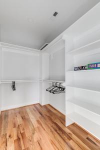 an empty closet with white walls and wooden floors at Charming 3Bedroom Home in Vibrant Church Hill - Walk to Parks and Dining in Richmond