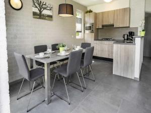 a kitchen and dining room with a table and chairs at Cottage in Gelderland with Fenced Garden in Plasmolen
