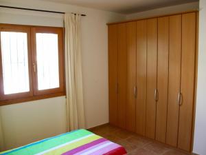 a bedroom with wooden cabinets and a window at Villa in Monte Pego near Stunning Beaches in Adsubia +27 photos