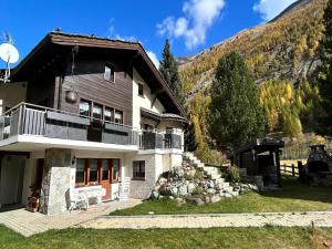 a house with a balcony on the side of it at Chalet in Saas Fee near Ski Slopes in Saas-Grund