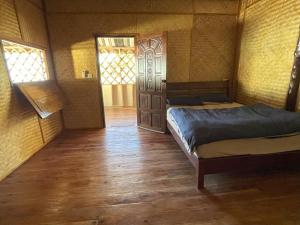 a room with two beds and a door with windows at Koh Jum Family Homestay in Ko Cham +55 photos