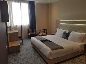 a hotel room with a large bed and a window at Blue sky hotel in Oran +32 photos