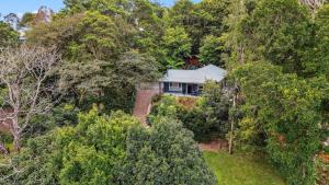 an aerial view of a house in the forest at Wattle Cottage - A Stylish Hinterland Escape in Maleny