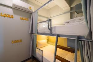 a room with two bunk beds in it at Friends Hostel - Phuket Airport in Nai Yang Beach +47 photos