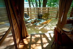 a balcony with two chairs and a table on a porch at nasusatoyamafield in Otawara