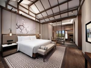 Postel nebo postele na pokoji v ubytování Song Hotel Chengdu Qingcheng