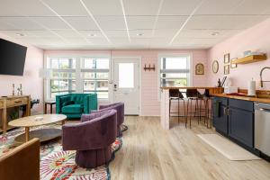 a kitchen with purple chairs and a table at Timberline Flats in Traverse City