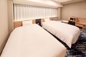 Postel nebo postele na pokoji v ubytování Washington R&B Hotel Kyoto Station Hachijoguchi