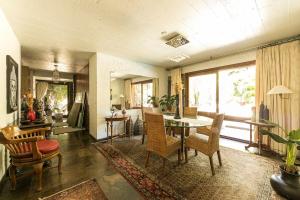 a living room with a table and chairs at Vila Balinesa in Porto Alegre +95 photos