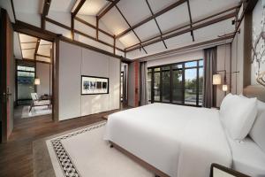 Postel nebo postele na pokoji v ubytování Song Hotel Chengdu Qingcheng