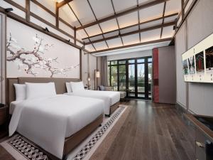 Postel nebo postele na pokoji v ubytování Song Hotel Chengdu Qingcheng