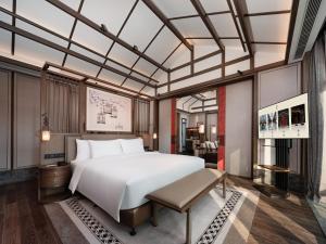 Postel nebo postele na pokoji v ubytování Song Hotel Chengdu Qingcheng