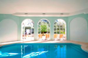 a swimming pool in a house with a large window at Casa de Mogofores in Anadia